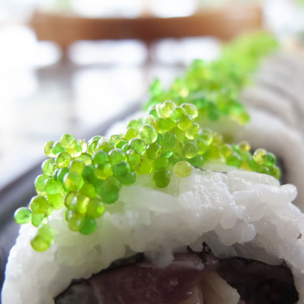 blue jack maki roll sprinkled with green tobiko at the sushi bar athens